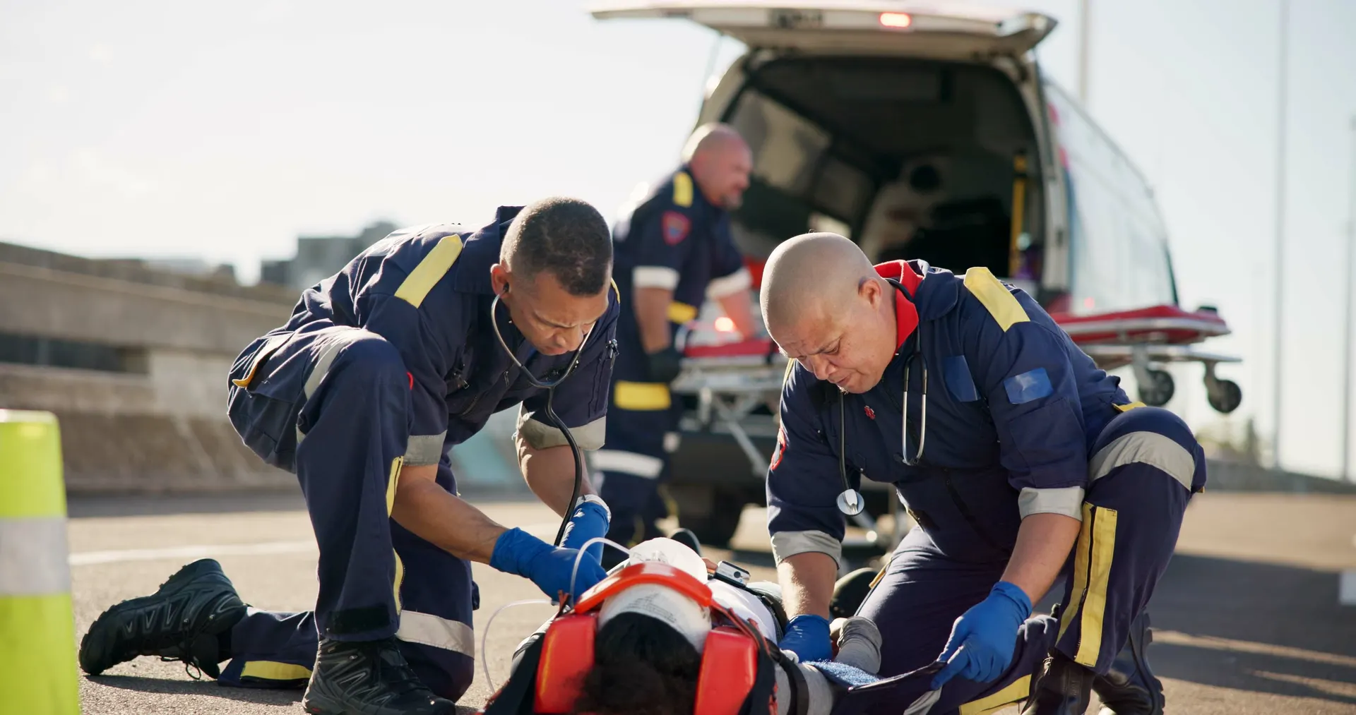 Paramedic crew lifting a patient stretcher