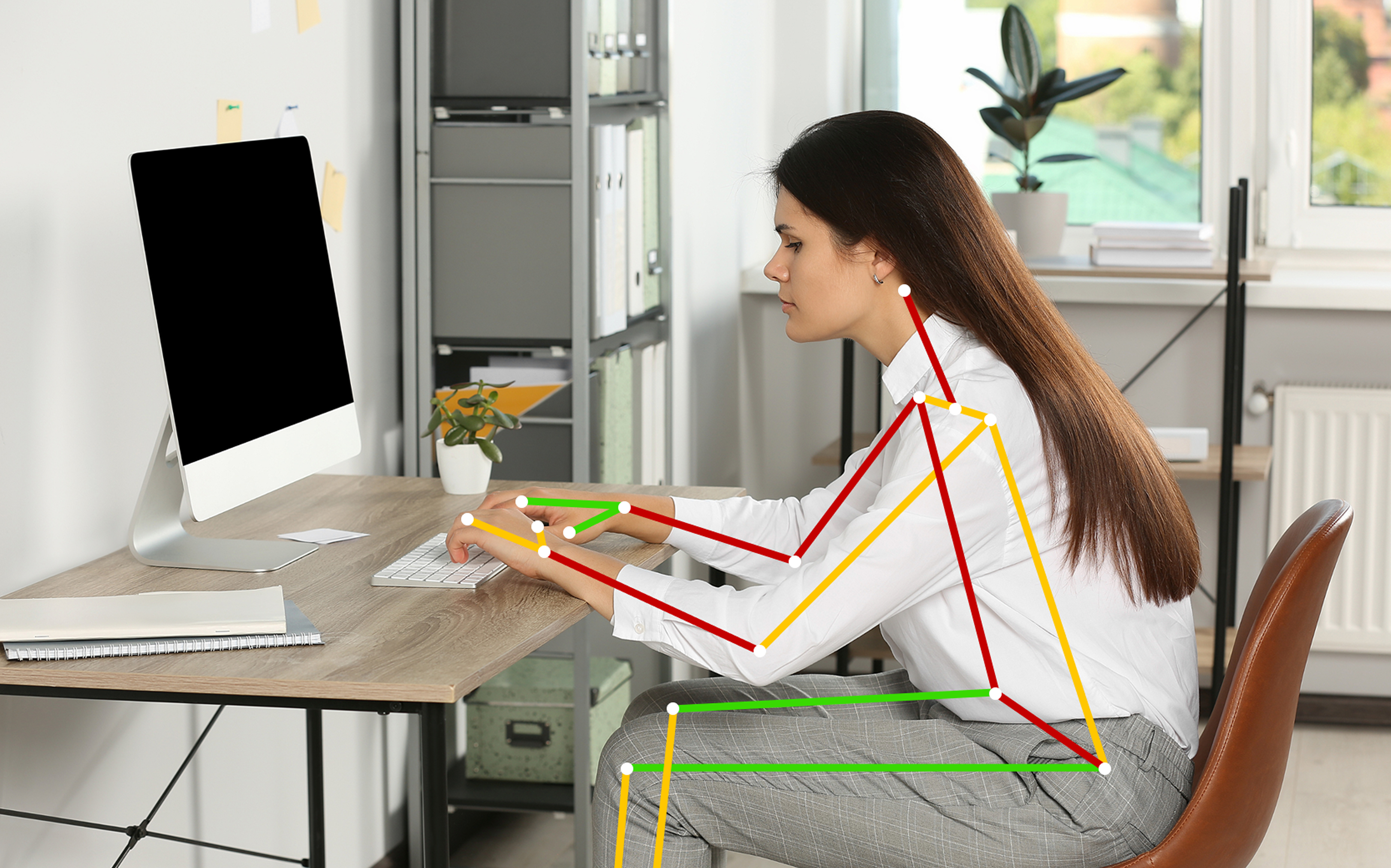 Office worker at a desk with BalanceFlo posture analysis overlay